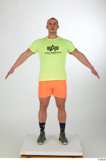 Joel a-pose dressed green sneakers orange shorts sports standing whole…